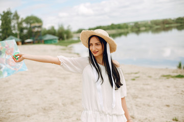 Beautiful girl in a white dress. Woman with a kite