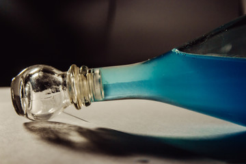 glass bottle with blue liquid
