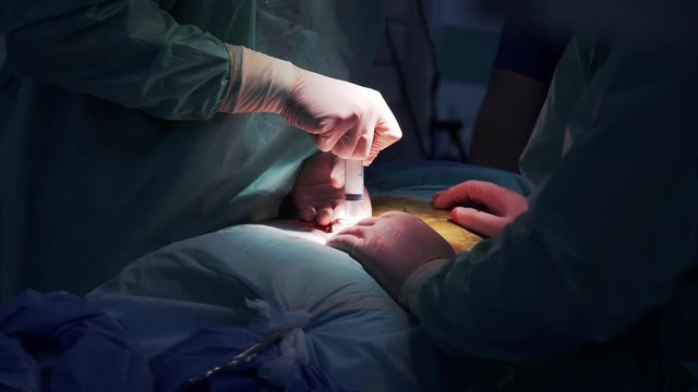 carrying out an operation in a hospital. syringe handling