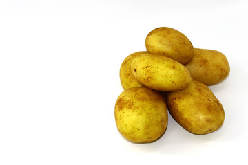 A small slide of six potatoes young and clean on a white background