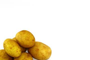 Six potatoes in the corner of the photo on a white background