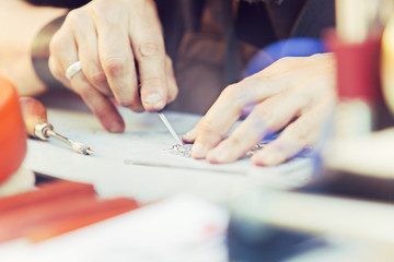 Engraver. Detail of hands of young craftman