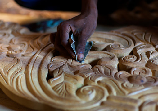 Hand polishing wooden carved bed in lamu, Kenya
