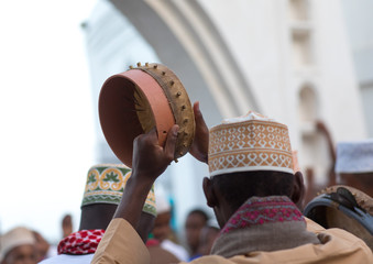 Sunni muslim men playing tambourines during the maulidi festivities in the street, Lamu county, Lamu town, Kenya