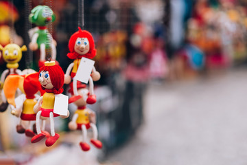wooden toy dolls in the gift shop. Traditional handicraft puppet dolls are sold on the market in...