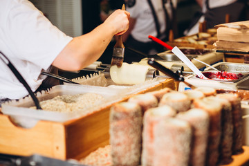 The most popular dessert in Prague. Grilled food. Manufacturer trdelnikov in Prague. Selective focus
