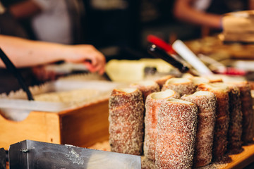 The most popular dessert in Prague. Grilled food. Manufacturer trdelnikov in Prague. Selective focus