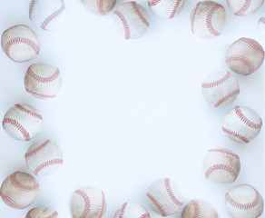 Baseball border on white background with balls and copy space for sports graphic or banner.