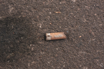 black stain on the pavement and cigarette butt lying next to him 8