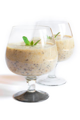 Healthy banana smoothie in glass with mint isolated on white background