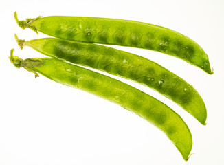 Green peas (chícharos, petipuas), tender and very fresh (with drops of water). Isolated on white background.