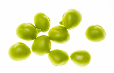 Green pea seeds (chícharos, petipuas), tender and very fresh (with drops of water). Isolated on white background.
