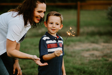 Mom and son playing with sparkler fireworks together