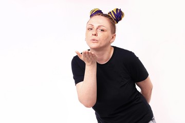 Close up portrait of woman with dreadlocks on the head, she is sending an air kiss, isolated on white background.