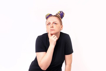 Attractive woman with dreadlocks on the head and freckles on face standing daydreaming with her...
