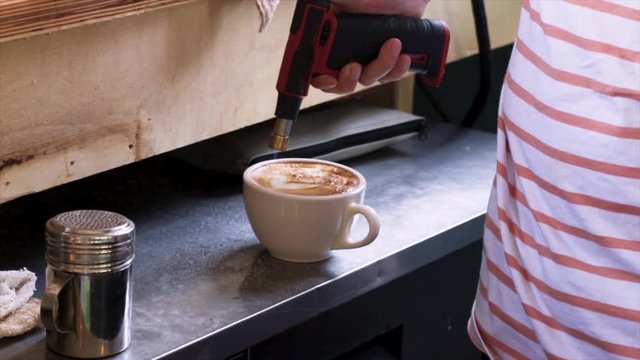 Barista Prepares Latte Art At Coffee Shop