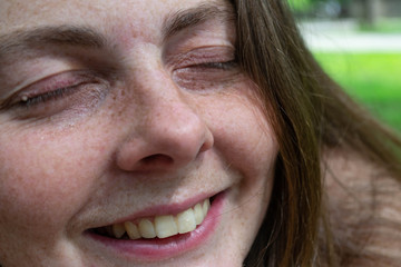 a smiling woman feeling a sense of enjoyment and relaxation