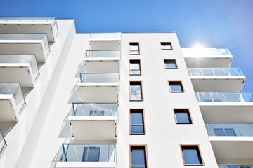 Modern apartment buildings on a sunny day with a blue sky. Facade of a modern apartment building