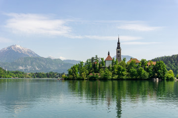 View of the Church of the Assumption and surrounding mountains in Lake Bled, Slovenia.