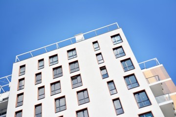 Modern apartment buildings on a sunny day with a blue sky. Facade of a modern apartment building
