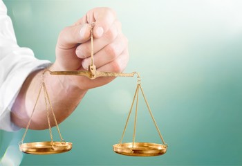 Close-up businessman holding Scales in hand
