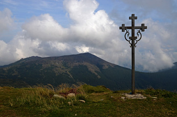 The peaks of the Carpathian Mountains. Mountain ranges covered with forests under blue clouds