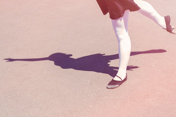 shadow of a dancer girl which makes dance moves in a bathing suit for dancing and ballet shoes