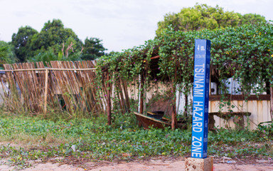 2004 Tsunami height marker in Thailand. Tsunami hazard zone warning sign.