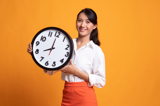 Young Asian woman with a clock.