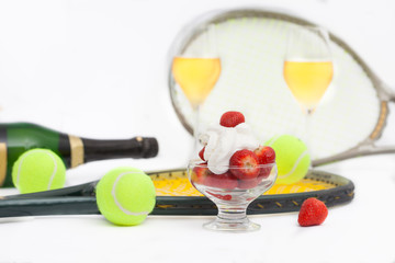 Strawberries with whipped cream, glasses with champagne and  tennis equipment on Wimbledon...