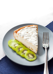 Homemade cottage cheese and semolina cake with kiwi fruit and cream on a plate