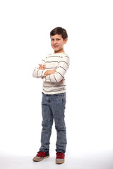 Naklejka premium Full-length portrait of a smiling teenager boy with arms crossed, isolated