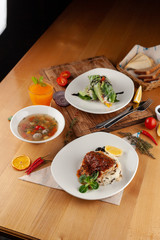 Set lunch menu in a restaurant: fish with steamed rice, light vegetable soup with meatballs and vegetarian spring roll