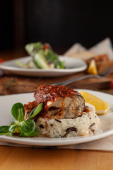 Close up of a steamed fish in tomato gravy with wild boiled rice for diet dinner in a cafe