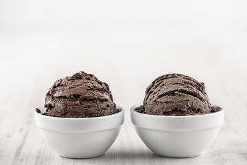 Chocolate ice cream with bowl on wooden background