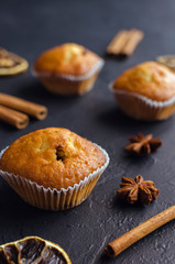 Sweet muffins with on dark textured background.