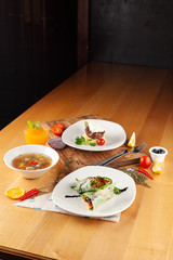 Steak with mashed potatoes,?light vegetable soup with meatballs and vegetarian spring roll for healthy diet lunch, placed on a wooden table with sidelight