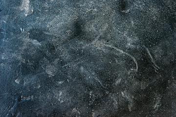 Old dark concrete background with white splatter