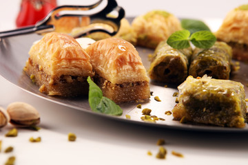 Middle eastern or arabic dishes. Turkish Dessert Baklava with pistachio on dishes