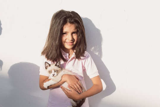 little children and pet puppy cat in outdoors image
