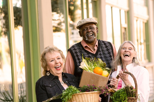Laughing Seniors Returning from Farmers Market with Groceries