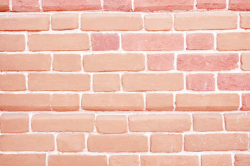 Red brick wall with painted bricks.