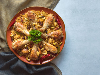 Homemade chicken Biryani on a blue background. 