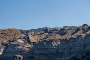 Castle and walls on cliffside and the mountaintop of Santorini