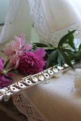 silver flute with a bouquet of pink peonies, color photography © olga_63