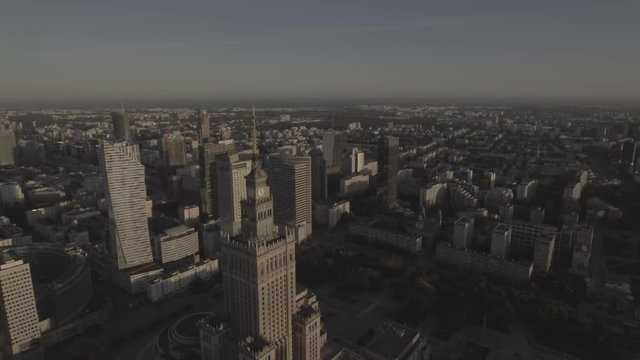 Aerial shot of the city of Warsaw at sunrise. Financial office, business district. Reflection of the sun in glass skyscrapers. Shot on 4k.