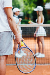 A tennis player  man prepares to serve a tennis ball during a match..