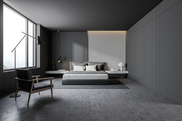Naklejka na ściany i meble Gray and wooden bedroom interior with armchair