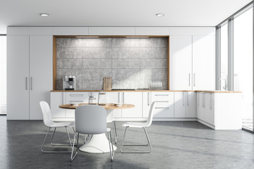 White and concrete kitchen with round table