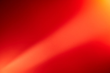 Light red diagonal ray of light divides a red background